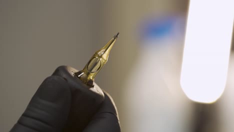 macro shot of tattoo machine needle in motion during setting up, shot in slowmotion 120fps