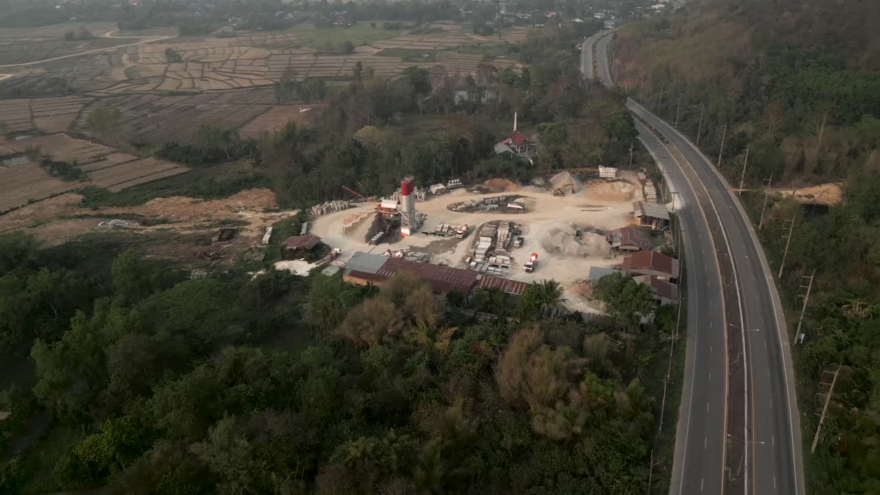 Aerial view of a concrete plant and highway in a rural landscape