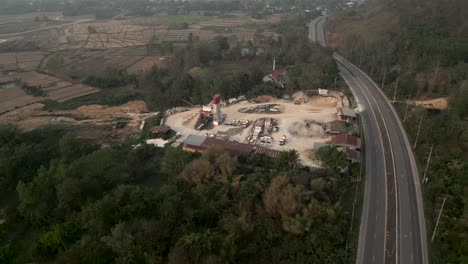 aerial view of a concrete plant and highway in a rural landscape