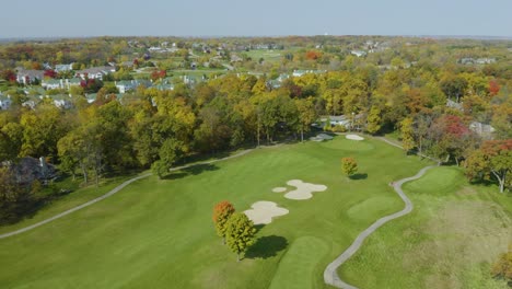 high aerial view above private golf course, fall landscape suburban neighborhood