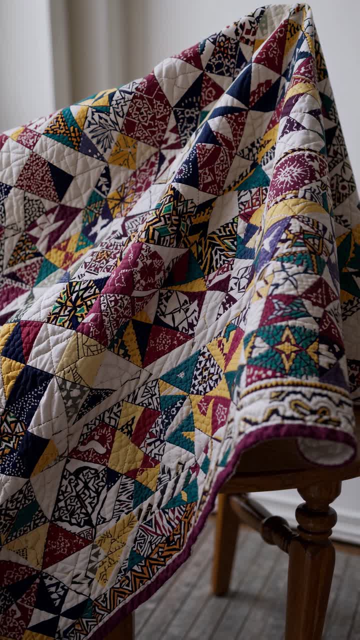 Colorful Patchwork Quilt Draped Over a Wooden Chair