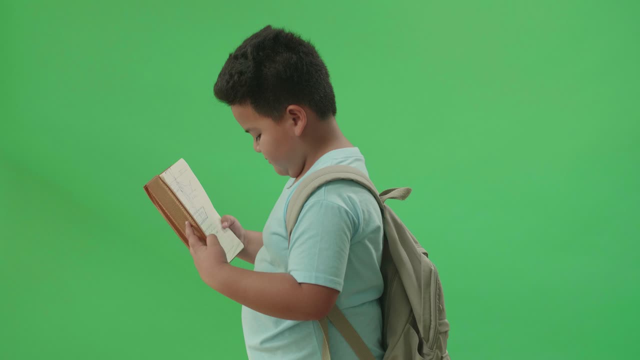 Boy Reading a Notebook
