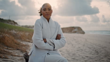 Serious-woman-thinking-ocean-beach-alone.-Frustrated-african-american-posing