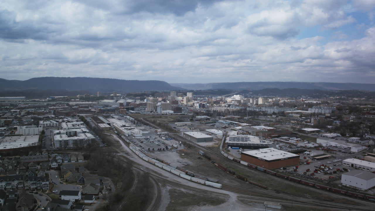 Fast aerial drone hyperlapse flying towards downtown Chattanooga on a cloudy day.