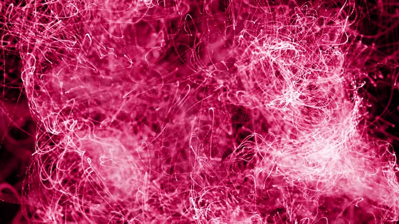 animación de rastros de luz rosada flotando sobre un fondo negro