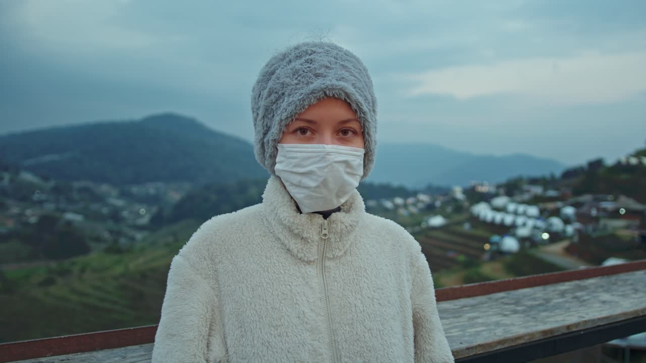 Woman wearing a mask in the mountains
