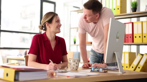 colleagues collaborating and discussing work in a modern office