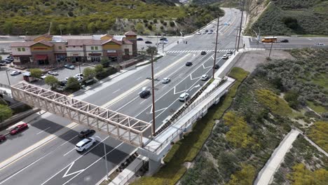Cars Commuting On A Street With A Intersection in Santa Clarita, Los Angeles. Aerial Flyover.