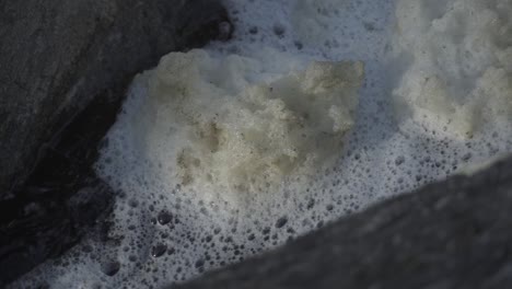 river foam flows over the water.