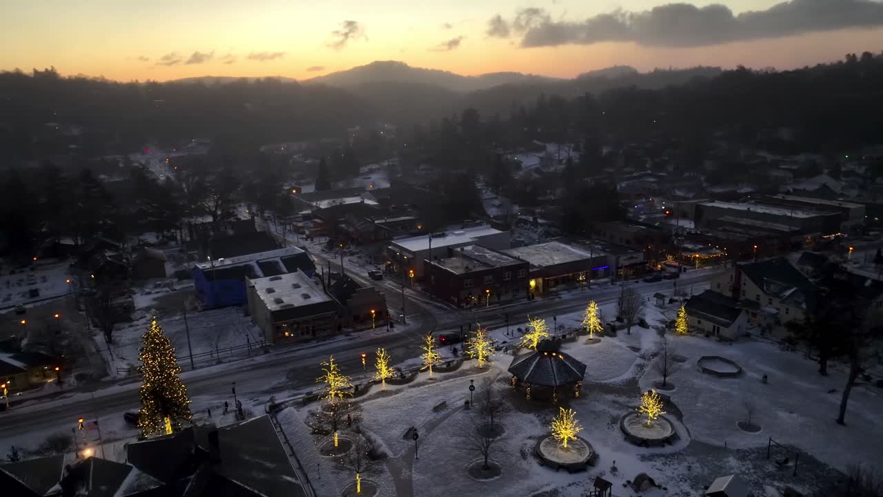 aerial orbit of blowing rock nc, north carolina with christmas lights at sunrise