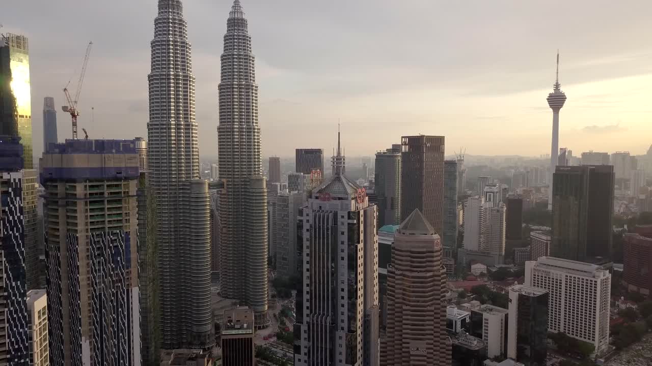 Kuala Lumpur Cityscape featuring Petronas Twin Towers and KL Tower at Sunset