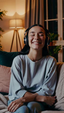woman listening to music on a sofa