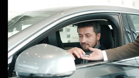 man buying a car in a showroom
