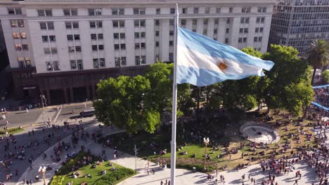 high rise argentina national flag waving in wind in lgbt pride parade, plaza de mayo, buenos aires