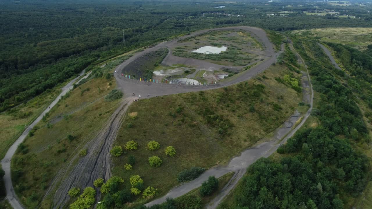 Aerial View of a Hill with a Path and Lake