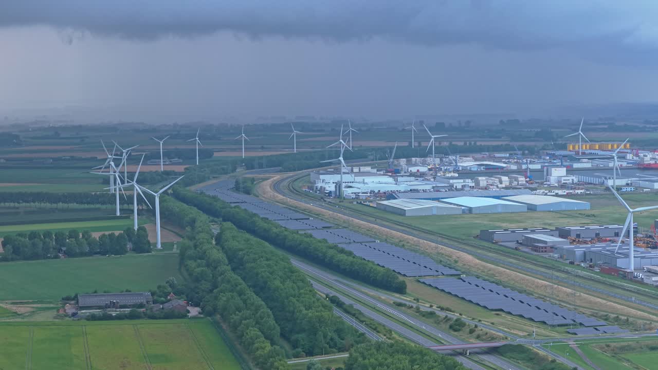 Highway beside renewable energy area with wind and solar farms, Netherlands