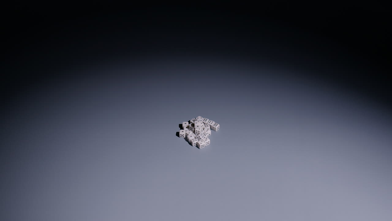 Slow-motion wide shot of large white die rolling into pile of tiny dice in middle of screen