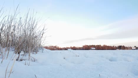 Two-people-on-atv-quad-bike-in-the-winter,-arctic-Lapland,-cinematic-slider-moving-right