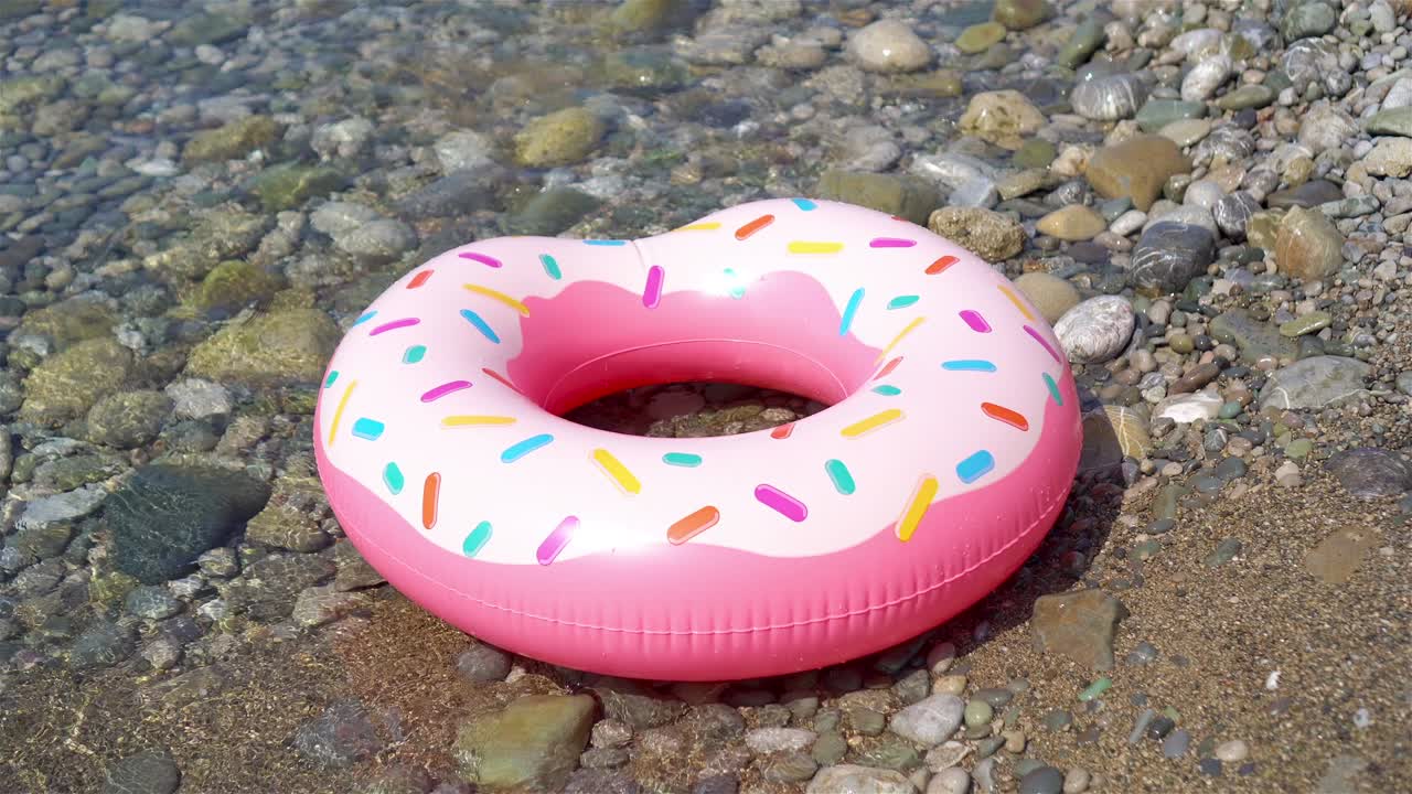 Inflatable colorful Rubber Ring floating on the seashore