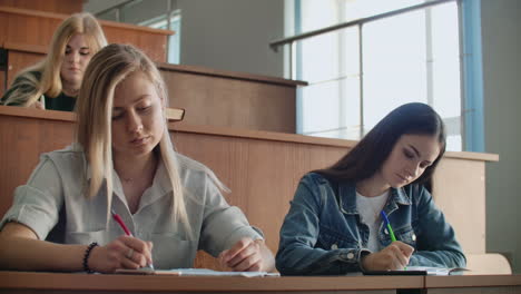 the college current audience in which students listen to the teacher and write a short film report in the notebook. transfer knowledge and educate students.