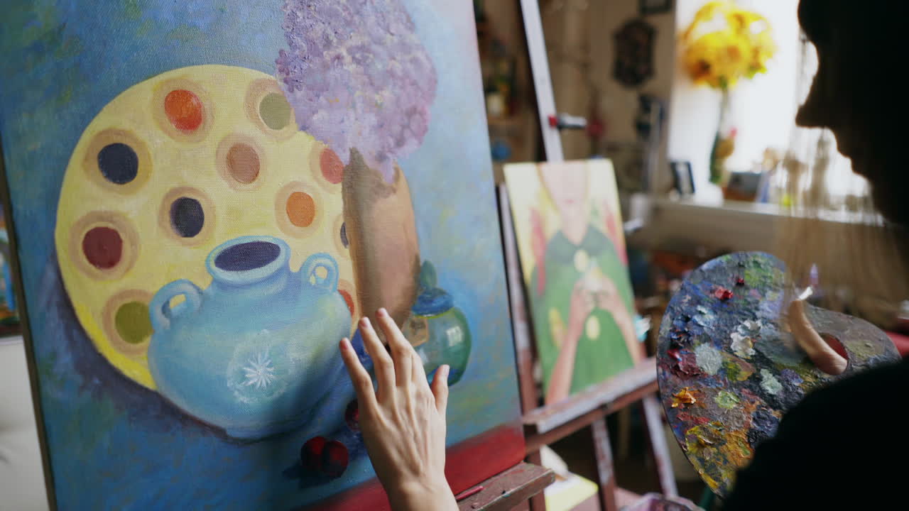 Woman painting a still life in an art studio