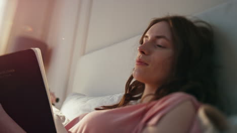 closeup girl planning schedule in morning bed. pensive calm woman writing diary