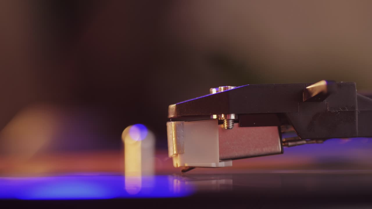 Retro Vinyl record player playing music, close-up macro shot of vintage LP disc old phonograph spinning. Retro music player.