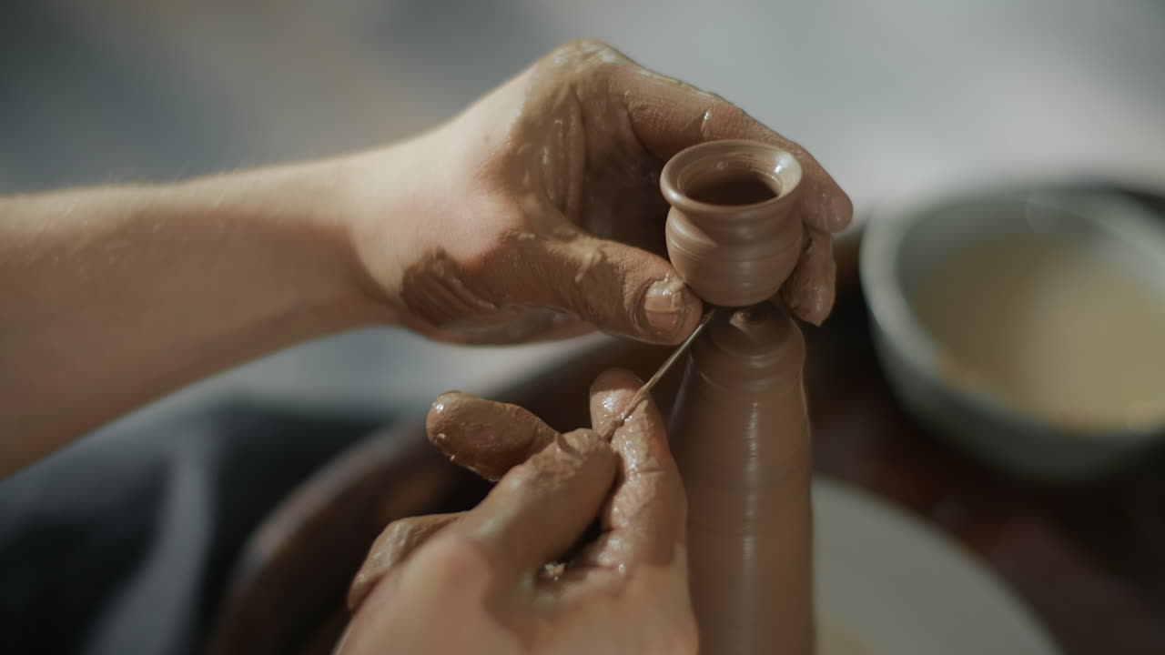 Hands Shaping Clay Pottery on a Wheel