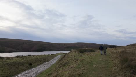 Young-boy-and-his-mother-walking-on-a-rural-footpath-on-a-day-out-in-the-country