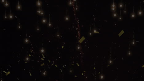 animation of gold confetti falling over fireworks exploding, on black