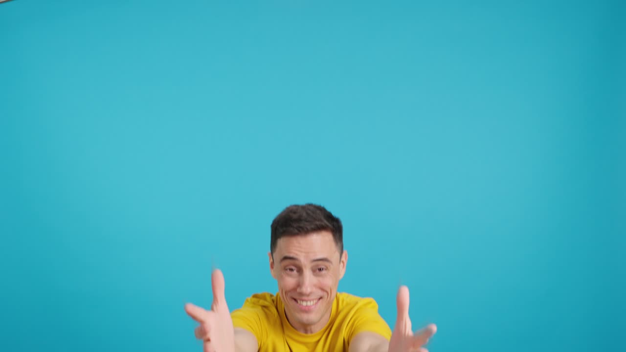A cheerful man in a yellow shirt