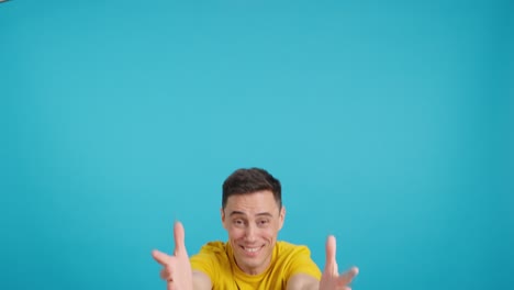 A cheerful man in a yellow shirt