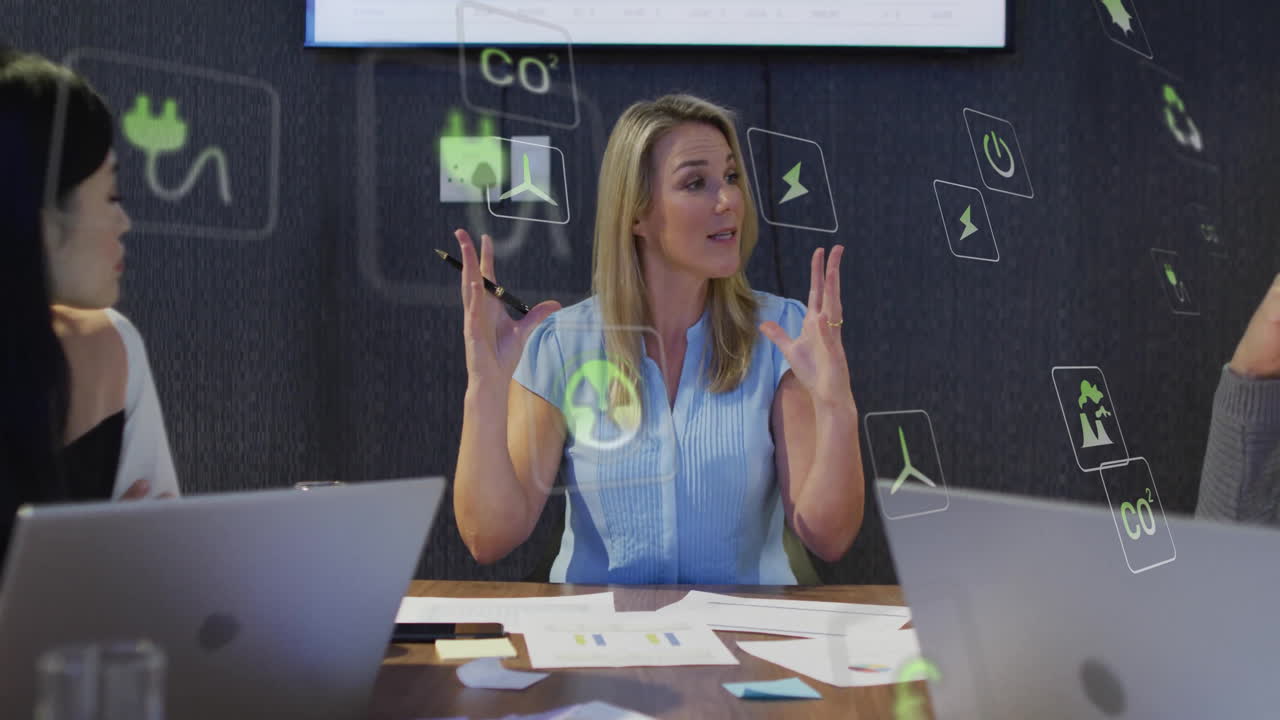 Discussing energy solutions, businesswoman using animation icons at conference table