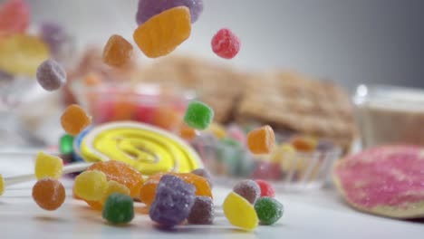 sugar coated jelly beans candy falling into a table - slow motion