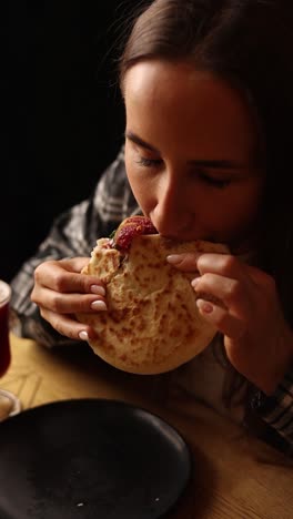 woman eating a fig pita