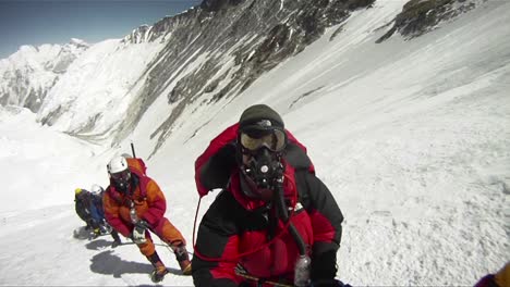 sweeping shot of line up of climbers