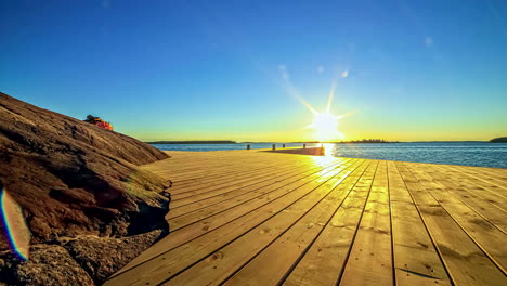 wunderschöne zeitrafferaufnahme eines stegs und piers bei sonnenuntergang mit meer