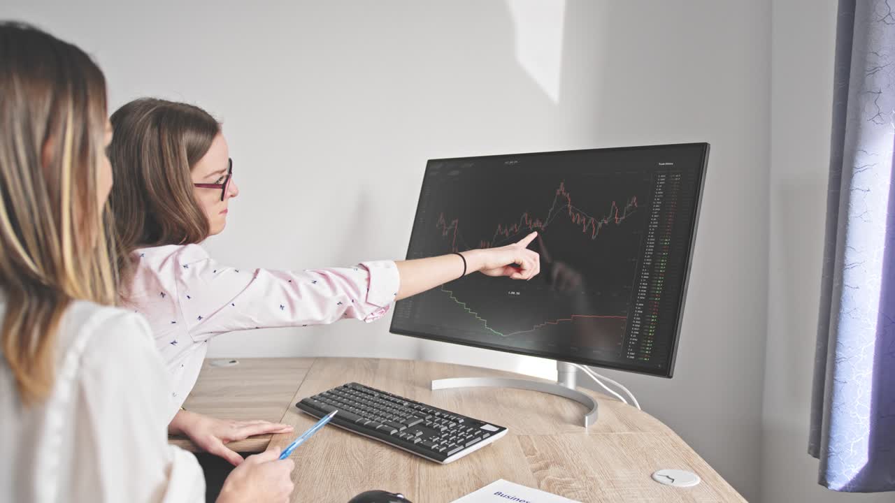 dos mujeres de negocios en una oficina en casa están deseando el éxito, piso de negociación de la bolsa