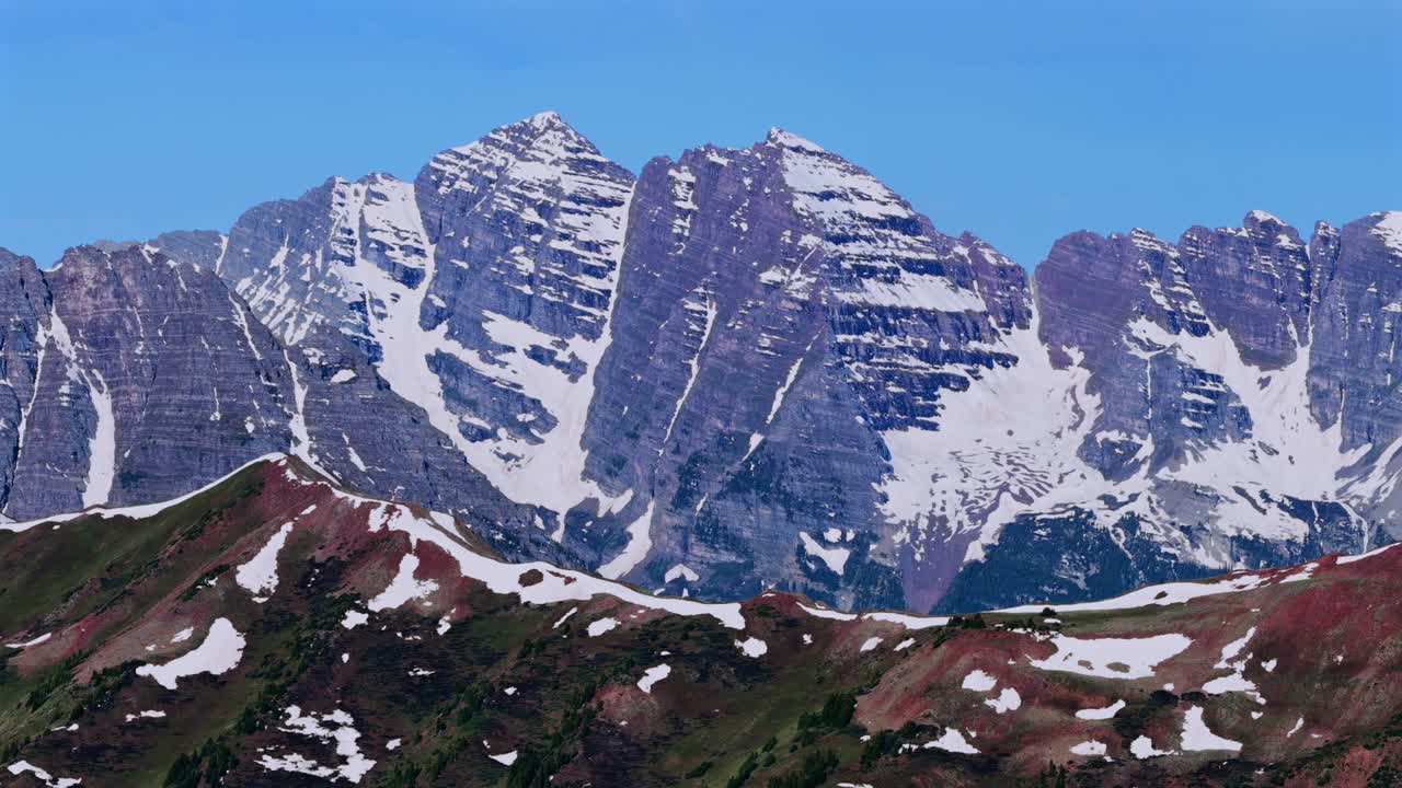 Summit of Pyramid Peak Maroon peak North Maroon Bells Wilderness aerial drone parallax right Colorado panorama Aspen Highlands bowl spring summer sunny morning blue sky clouds Rocky Elk Mountain Range