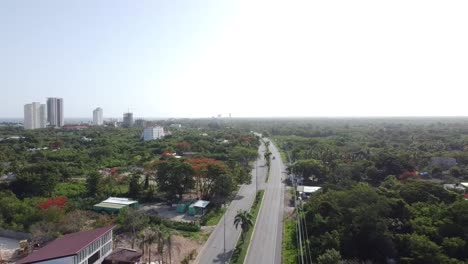 aerial-view-of-the-road-with-little-traffic-to-juan-dolio-in-dominican-republic,-vacation-and-tourism-trip-in-the-country