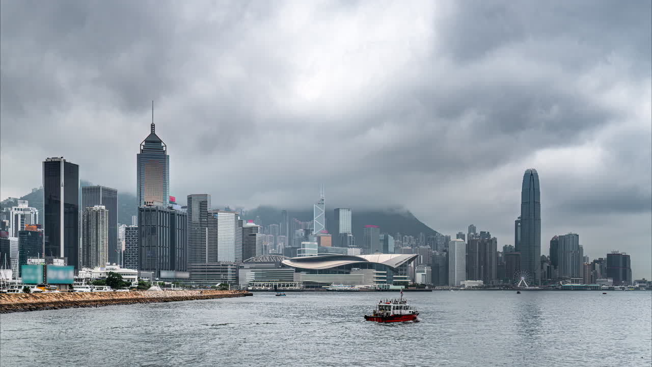 Time lapse of clouds moving over skyscrapers and Hong Kong Convention and Exhibition Centre in Wan Chai