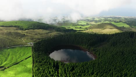 Fly-over-Canário-Lagoon-with-São-Miguel-shoreline-backdrop,-Azores