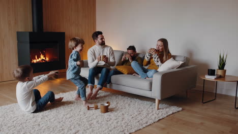 family relaxing by the fireplace