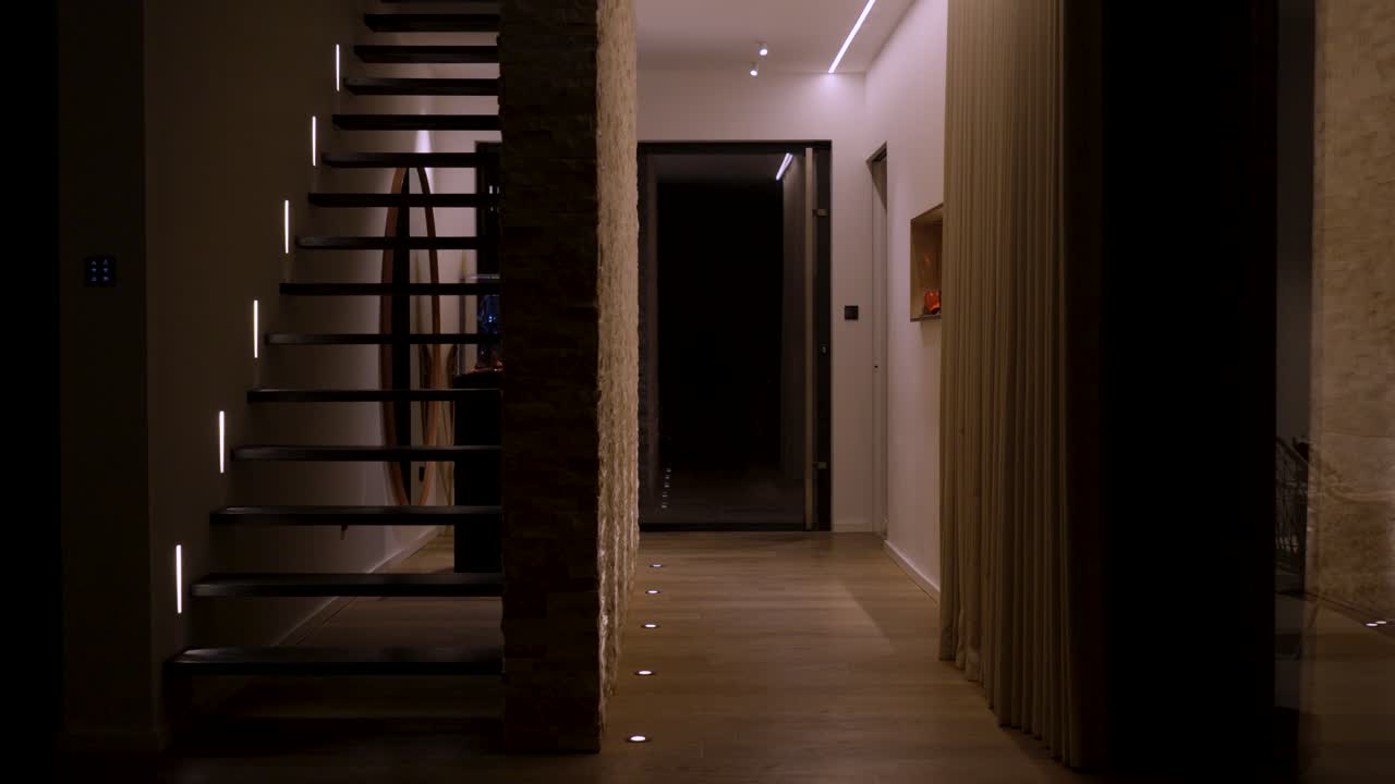 Slow establishing shot of a villa at night revealing the staircase
