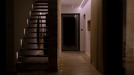 slow establishing shot of a villa at night revealing the staircase