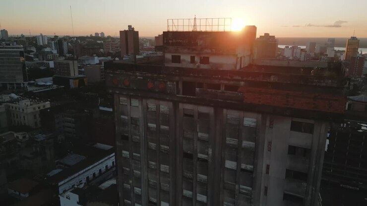 Aerial around an empty run down building block at sunset in downtown Asuncion, Paraguay