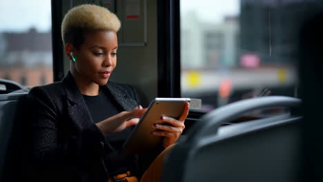 Woman using tablet on a bus