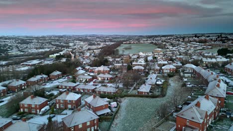 freezing cold winter cinematic aerial view of a delicate pink and blue early morning sunrise sky