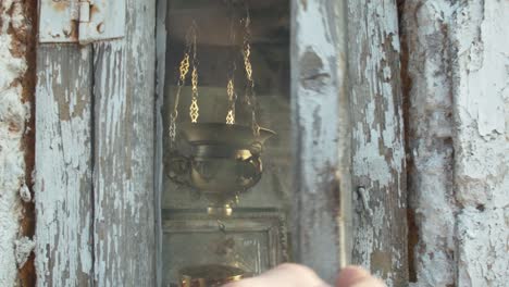 a small shrine in greece gets opened by a person