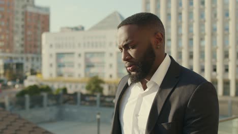 businessman walking on street. business man in suit looking at camera outdoors